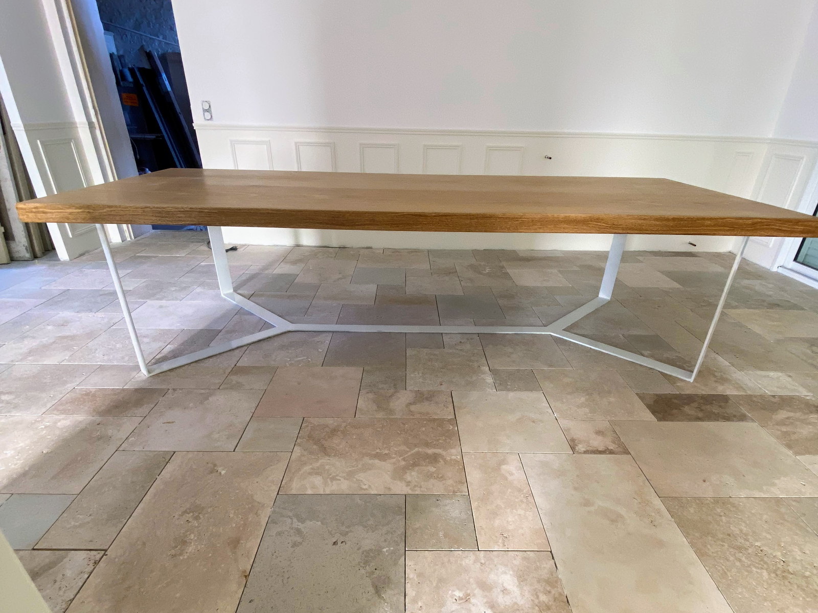 Table sur mesure avec plateau en bois dans un salon au sol en pierre naturelle